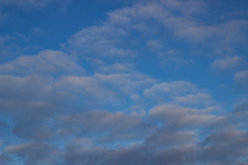 Blue sky background with white and gray clouds. Beautiful image of a huge sky and clouds. soft focus
