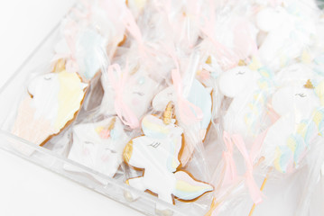Candy bar children's birthday party, white and pink, selective focus. Gingerbread with a unicorn