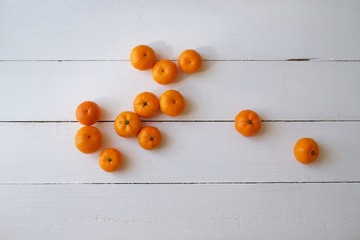 Naklejka na ściany i meble Small Chinese Mandarin Oranges isolated on old wooden background. Top view. Shatang Mandarin (Orange Red)