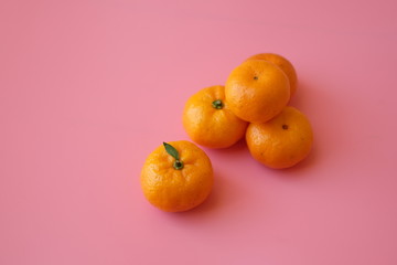 Small Chinese Mandarin Oranges isolated on pink background. Shatang Mandarin (Orange Red)