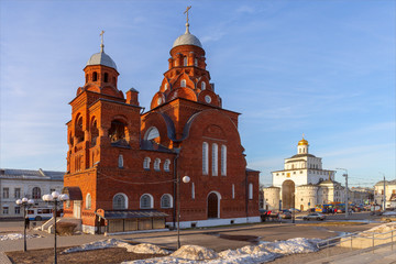 The setting sun illuminates the walls of the old Trinity Church. A quiet spring evening. Vladimir, Russia.
