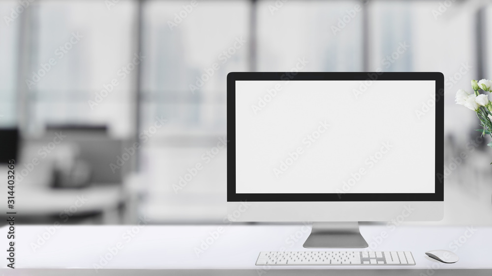 Poster cropped shot of simple workspace with blank screen computer on white table with blurred office room
