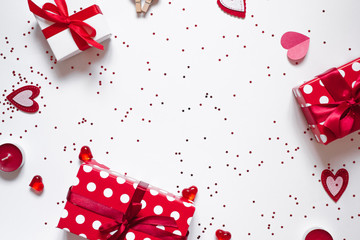 Frame of gifts, confetti, candles and hearts on a white background. The background of Valentine's day