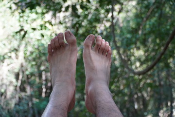 Isolated male feet natural background