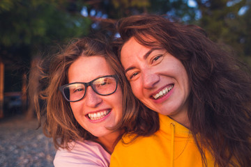 Fototapeta premium Two happy woman friends laughing