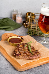 Grilled steak served with beer and sauce