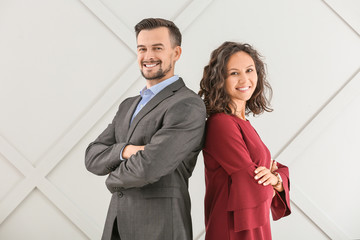 Portrait of young business people on grey background