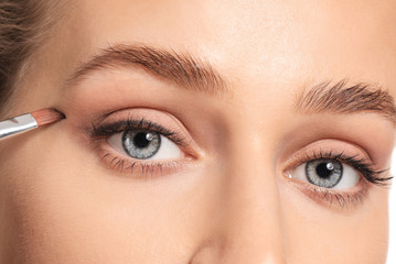 Young woman undergoing eyebrow correction procedure, closeup