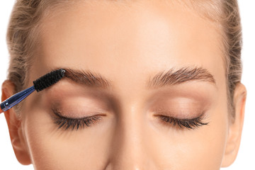 Young woman undergoing eyebrow correction procedure, closeup