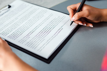 close up sign a contract. Female hand hold a pen and writing