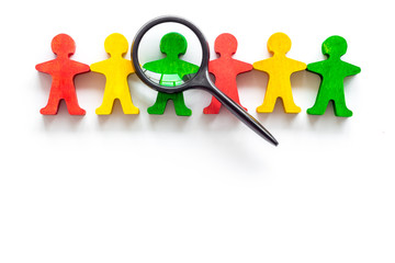 Tolerance concept. Social research. eople cutouts under magnifier on white background top-down copy...