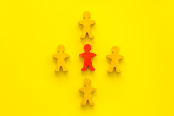 Leadership concept. People cutuots - red figure against others on yellow background top-down copy...