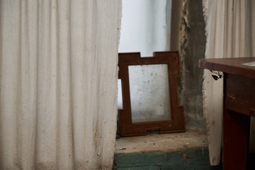 Interior of the abandoned house. You can see the shelf and the abandoned and dusty vessels. The...