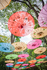 Chinese traditional multicolored umbrellas hanged on trees low angle view in Guilin, Guangxi province, China