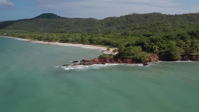 Beautiful rotating aerial over the colorful tropical water of Camp Bay, Roatan