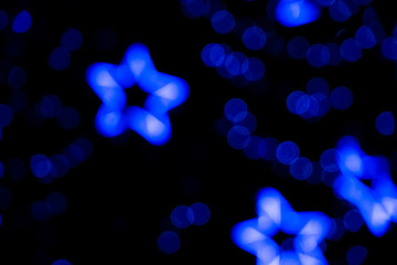 Defocused of blurred phantom blue star bokeh circle light from lighting bulb in the dark night for...