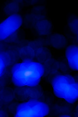 Defocused of blurred phantom blue star bokeh circle light from lighting bulb in the dark night for abstract background texture patterns
