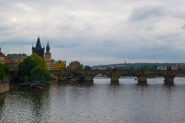 Vltava river flowing through Prague with Charles Bridge (Karlův most) and Old Town Bridge Tower (Staroměstská mostecká věž) at the background (Czech Republic)