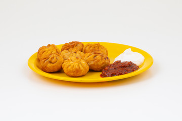 Fried Momos is a Traditional Dumpling Food From Nepal Served with Schezwan Sauce & Cream