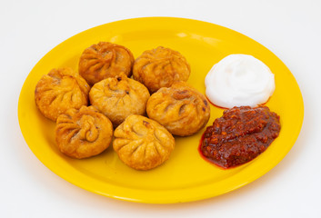 Fried Momos is a Traditional Dumpling Food From Nepal Served with Schezwan Sauce & Cream