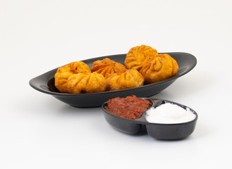 Fried Momos is a Traditional Dumpling Food From Nepal Served with Schezwan Sauce & Cream