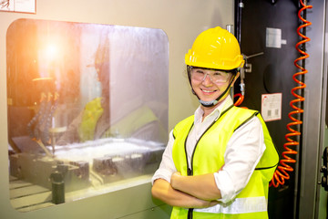 Asian woman engineer or business women are controlling machines in industrial plants.