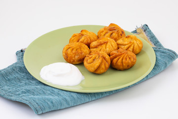 Fried Momos is a Traditional Dumpling Food From Nepal Served with Schezwan Sauce & Cream