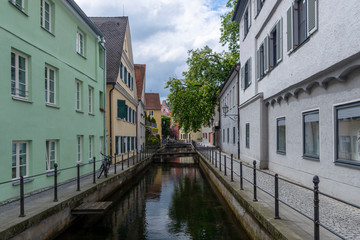 Fototapeta na wymiar Water channel passing trough the city of the old German town Memmingen