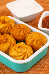 Fried Momos is a Traditional Dumpling Food From Nepal Served with Schezwan Sauce & Cream