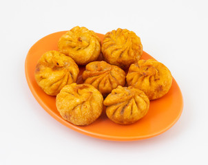 Fried Momos is a Traditional Dumpling Food From Nepal Served with Schezwan Sauce & Cream