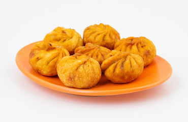 Fried Momos is a Traditional Dumpling Food From Nepal Served with Schezwan Sauce & Cream
