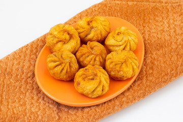 Fried Momos is a Traditional Dumpling Food From Nepal Served with Schezwan Sauce & Cream