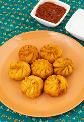 Fried Momos is a Traditional Dumpling Food From Nepal Served with Schezwan Sauce & Cream