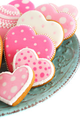 set of pink heart shaped cookies with patterns, light background