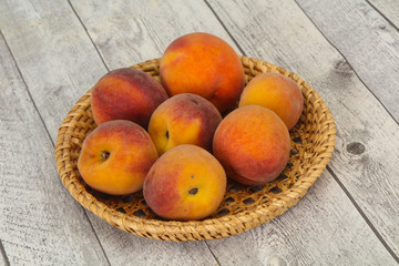 Peach heap in the wooden basket