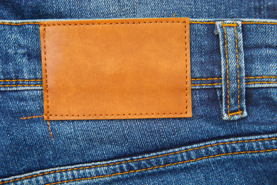 Brown leather empty copy space label texture. Back side of blue denim jeans  trousers background. Stock Photo | Adobe Stock