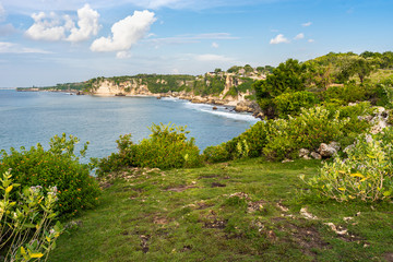 Nature of Bali Island in Indonesia. View from the high cliff on scenery coast with rocks,  stones and tropical greenery