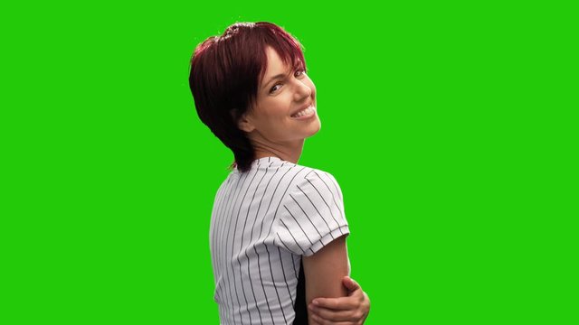 Victory gesture performed by cheerful middle aged woman on green screen