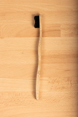 Bamboo toothbrush on wooden background