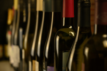 many bottles of wine stand in a row in the cellar