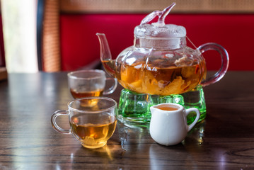 Glass teapot and cups on a wooden table in China