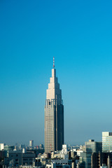 Obraz premium Japan / Tokyo - October 30 2019: NTT DOCOMO Yoyogi Building with sky in the morning. Japan city urbanscape real estate.