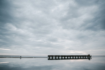 a compound train travels through a kind of salt lake in which a cloudy sky is reflected - 314422625