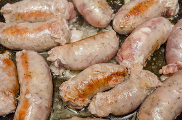 Sausages for grilling fried in a pan close-up