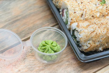 Set sushi Toto Maki, Bonito Maki, Akito Maki with wasabi on a wooden background. Top view, side View