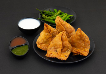 Indian Street Food Samosa or Samosas is a Crispy And Spicy Triangle Shape Snack Which Has Crisp...
