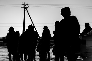 silhouettes of people refugees in the street. black and white