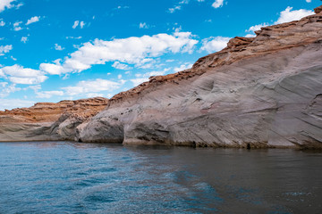 Fototapeta na wymiar View of narrow, cliff-lined canyon from a boat in Glen Canyon National Recreation Area, Lake Powell, Arizona.