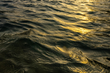 Sunlight hits The water surface at sunset.