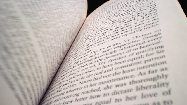 Quickly fanning through pages of a book in slow motion, filmed on RED 8K Camera 